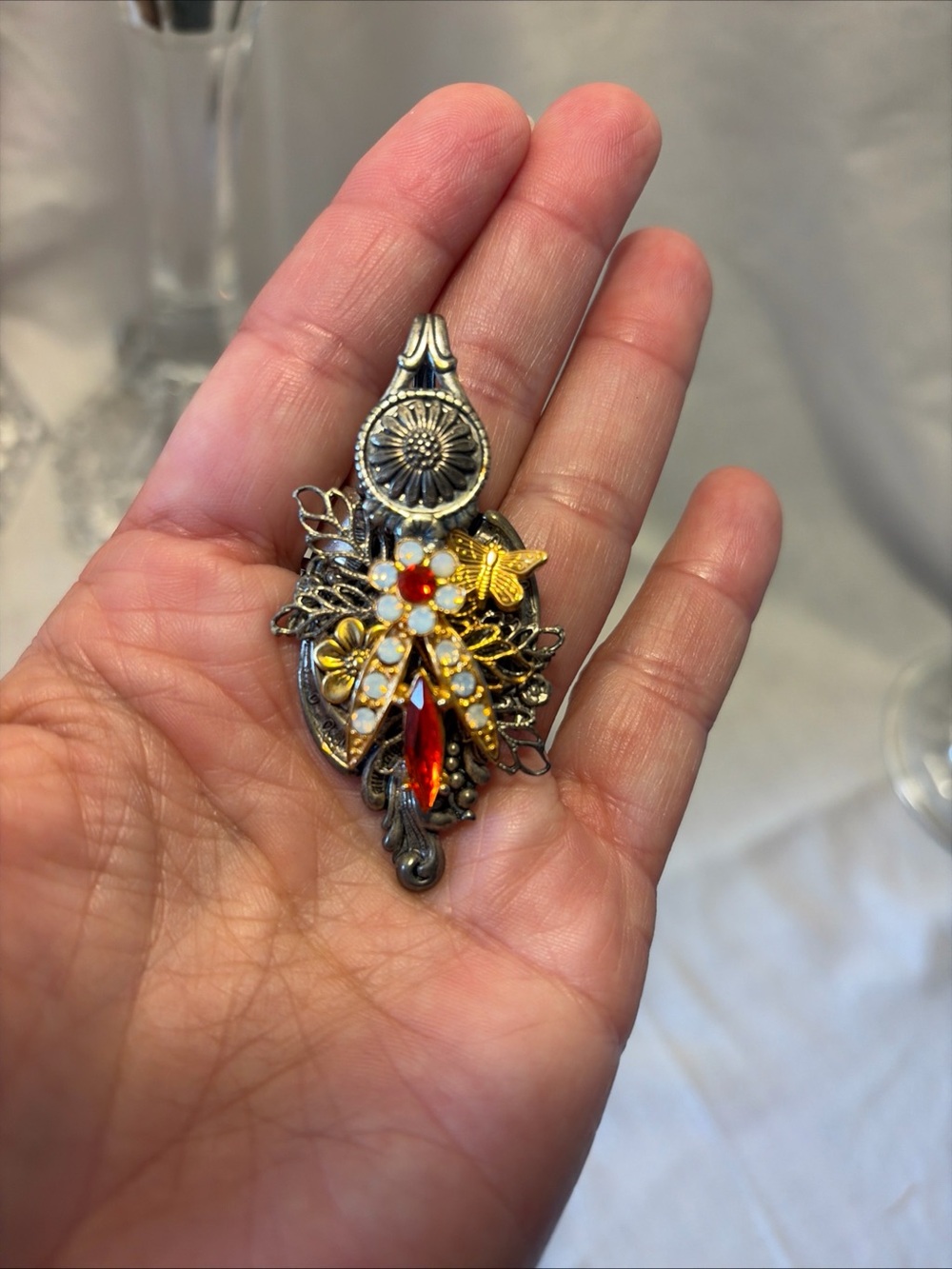 Handcrafted Silver-Tone Floral Pendant with Red Crystal Accent